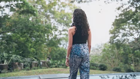 attractive female enjoys majestic terrace surrounded by green nature, handheld view