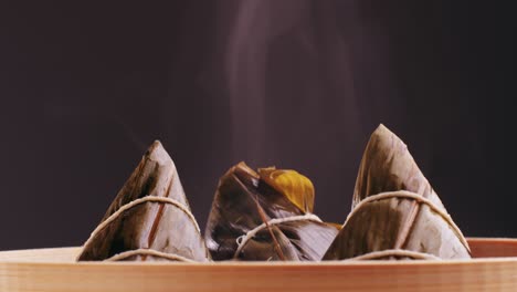 steaming zongzi in a bamboo steamer