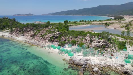 square fishing nets on shore of vietnam with view of binh tien beach