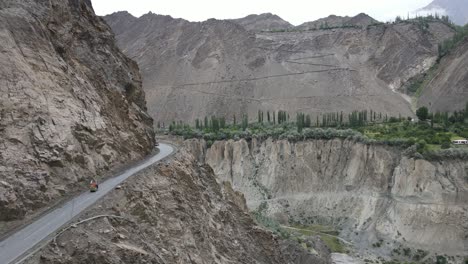 aerial view of hillside road and deep river canyon in hunza valley, pakistan