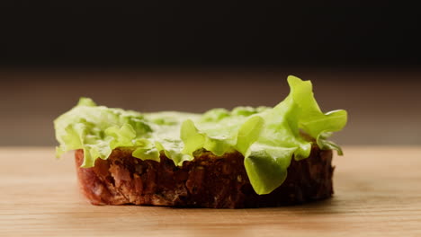 preparing a ham and lettuce sandwich