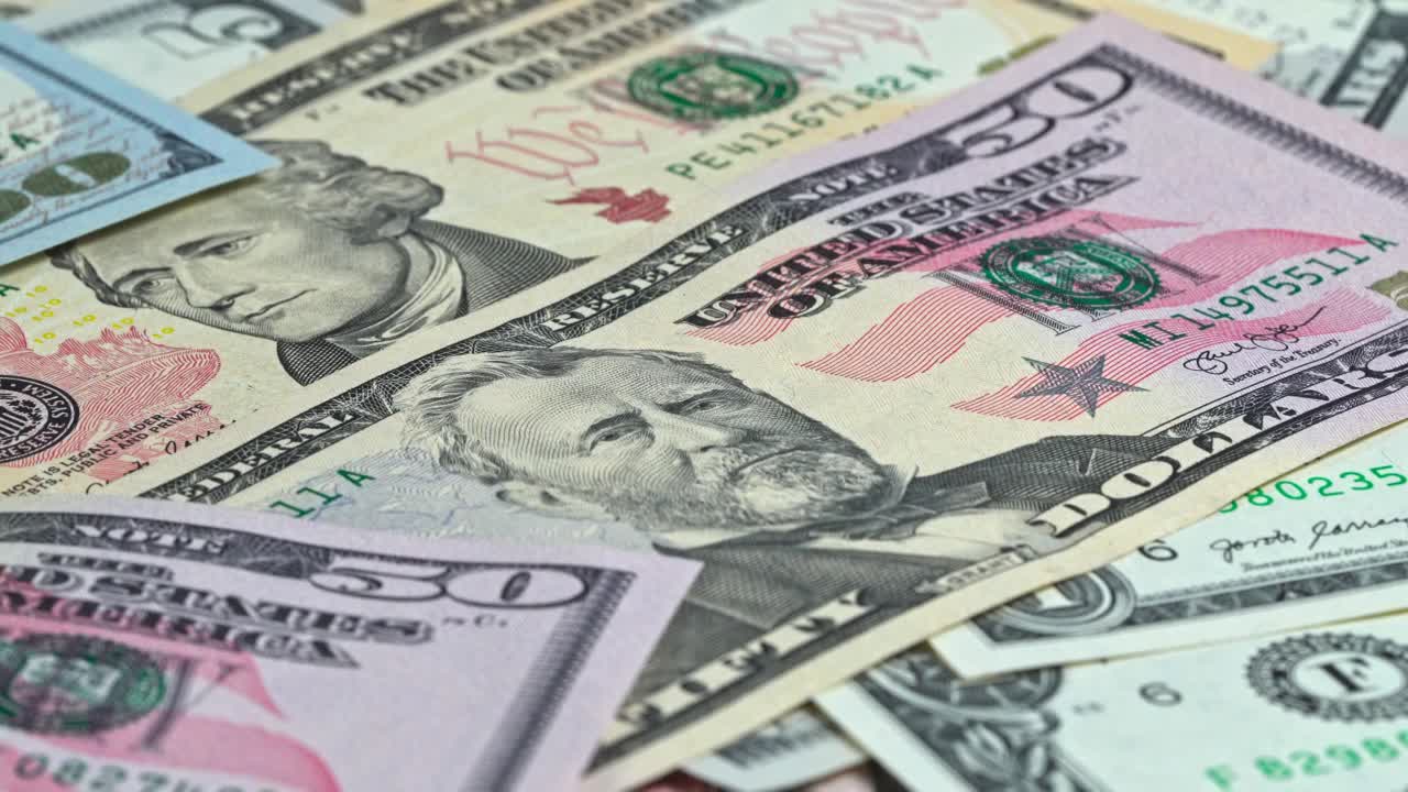 Cash displayed on a table with various denominations in focus