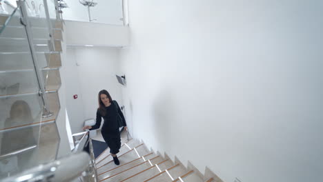 woman walking up stairs. brunette woman walking up the stair