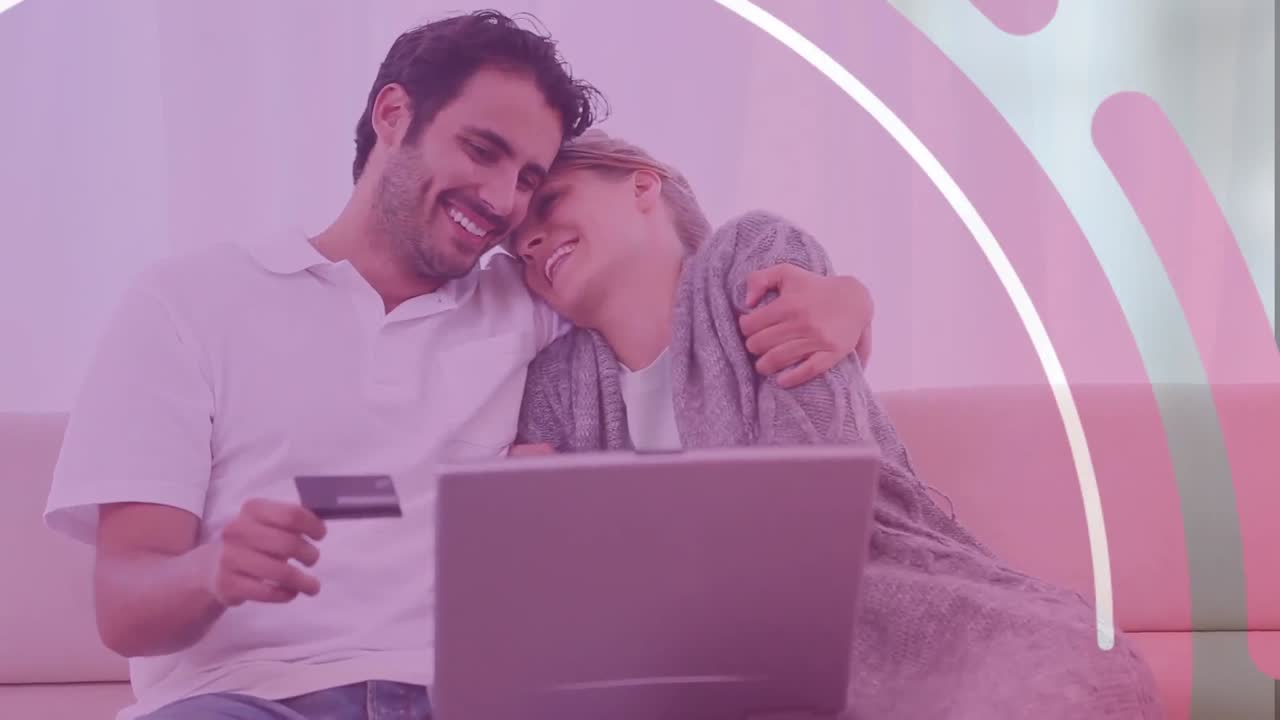 animación de formas sobre una pareja caucásica usando una computadora portátil