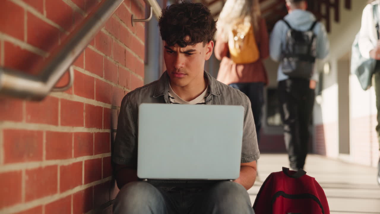 Teenage Student Working on Laptop at School