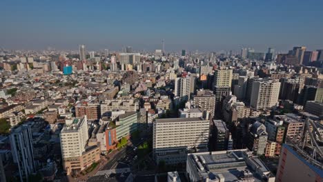 an extensive aerial view of tokyo's vibrant urban sprawl, including distant landmarks like the skytree, captured from the bunkyo civic center observatory on a clear day.