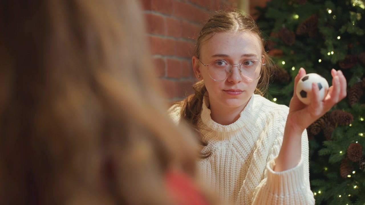 Junge Frau mit Brille drückt einen Stressball