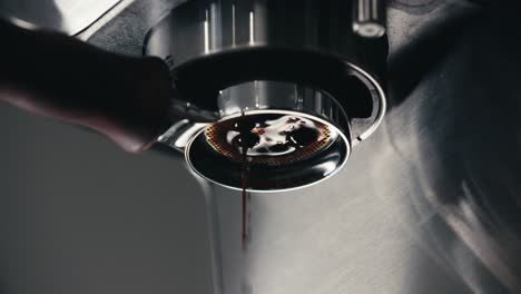 espresso machine pre-infusion pulling double shot coffee from bottomless naked portafilter with closeup of professional extraction at home or cafe in slow motion 4k