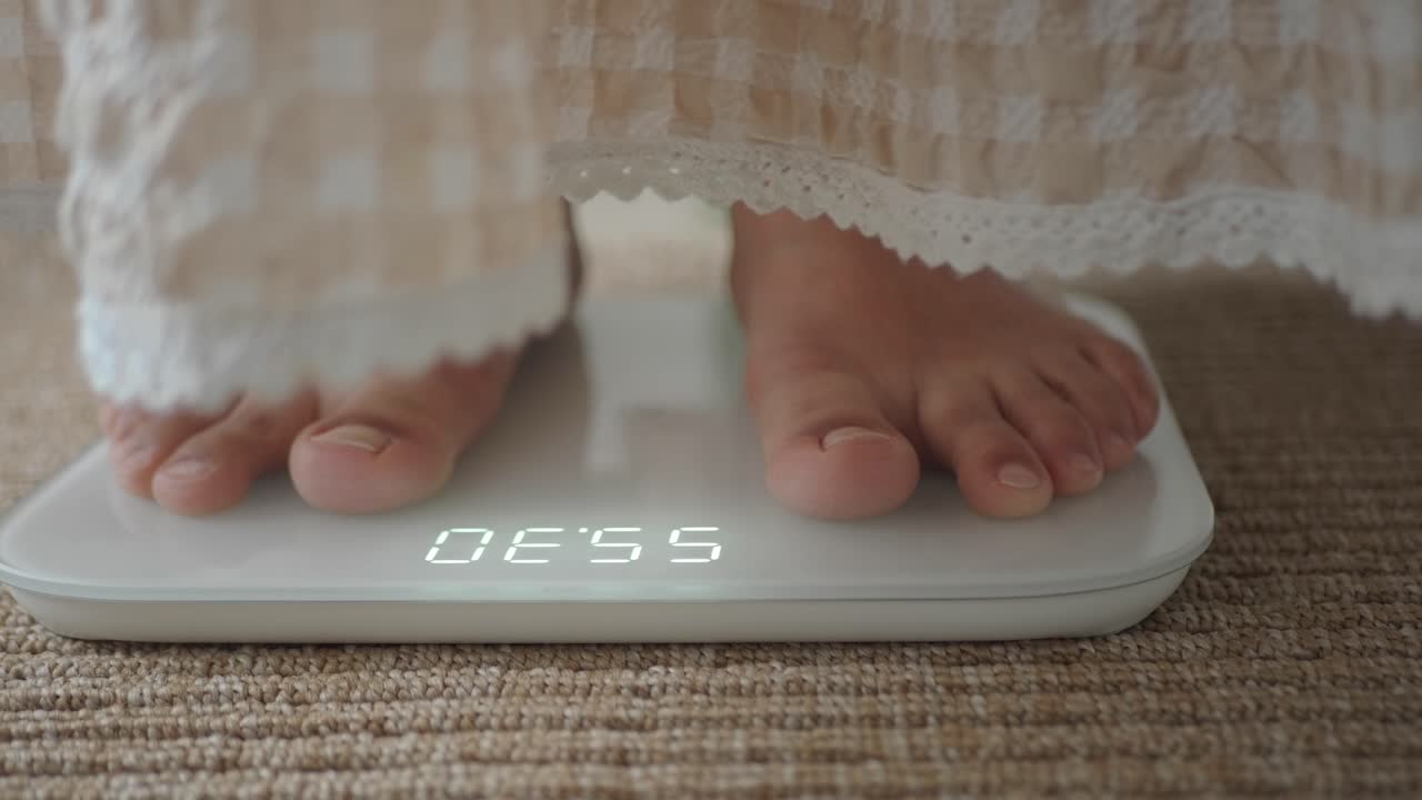 Close-up of Feet on Digital Weighing Scale Measuring Weight