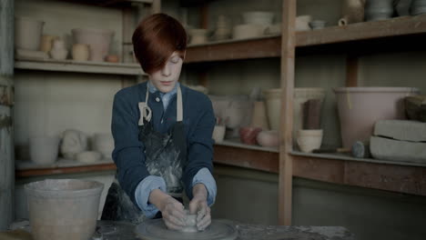teenager working on pottery wheel