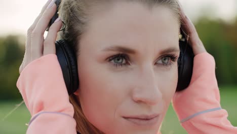Handheld-video-shows-of-woman-listening-to-music-by-headphones