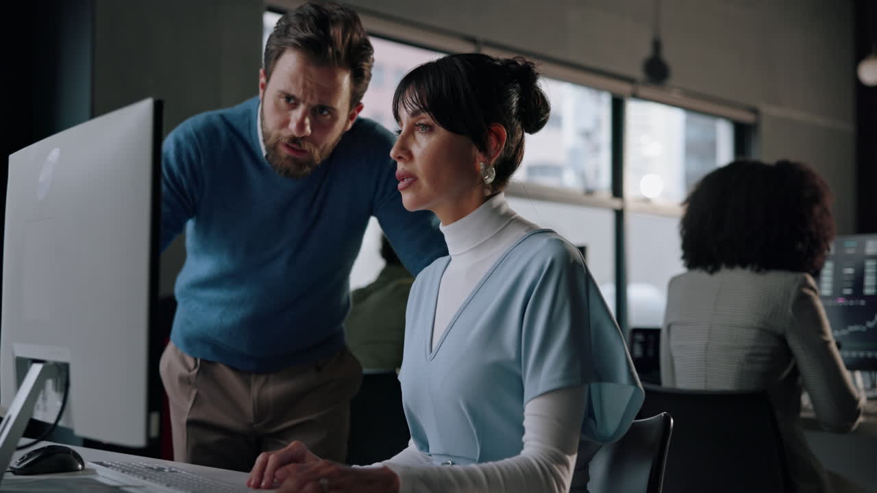 Two colleagues discussing work in the office