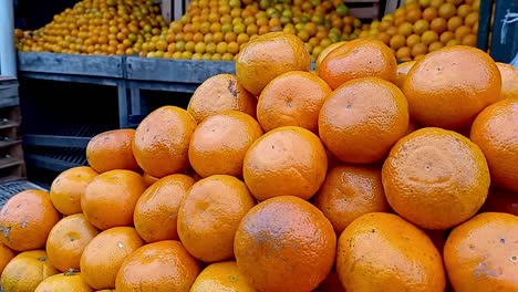 close up shot of delicious orange fresh fruits displayed in piles in local market, paraguay