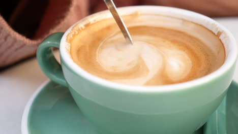 primer plano de un latte en una taza de azul azulado