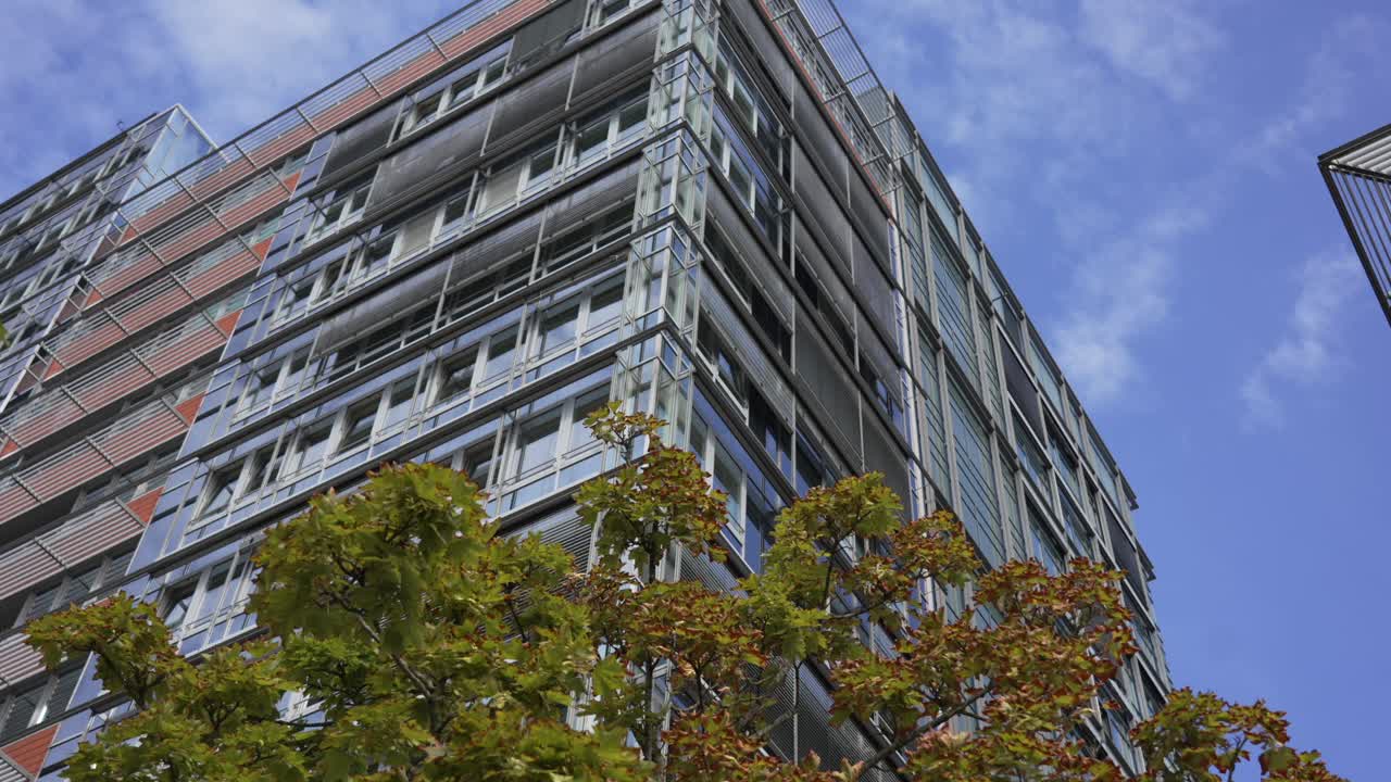 Modern building in Kiel, Germany, with glass facade against a bright blue sky on a clear day
