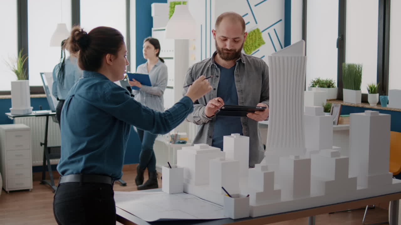 Architects collaborating on urban planning and design using architectural model