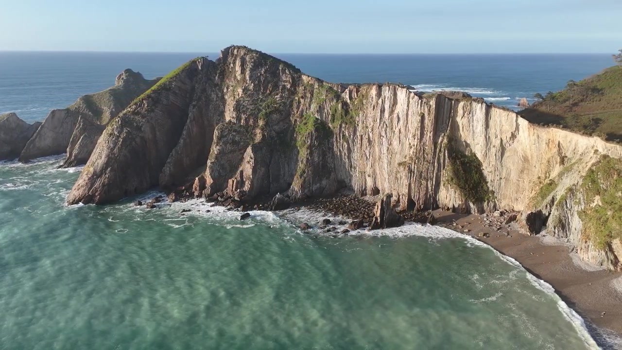 Drone view of Playa del Silencio cliffs and turquoise water in Asturias