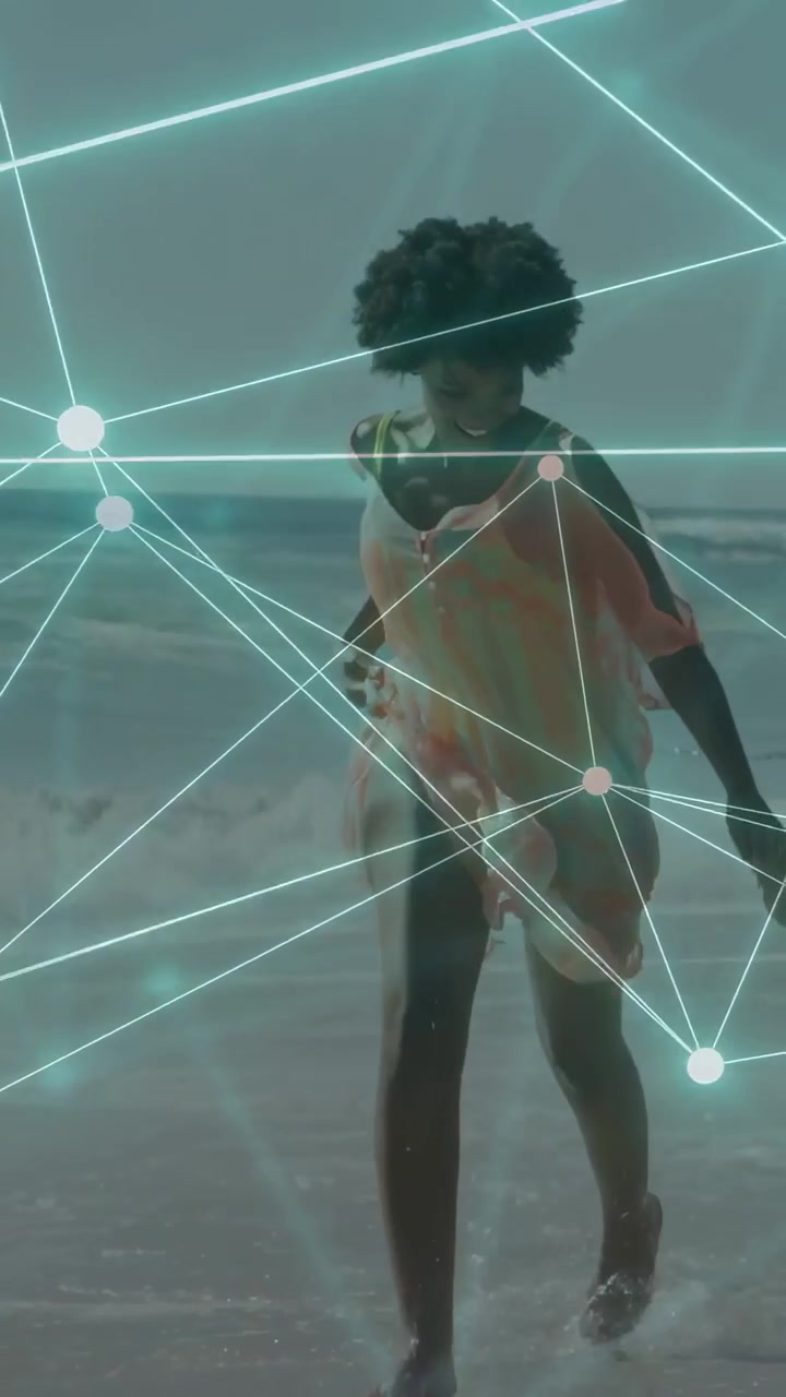Vertical video: Woman entering frame, splashing surf while nodes mapping her motion for marketing