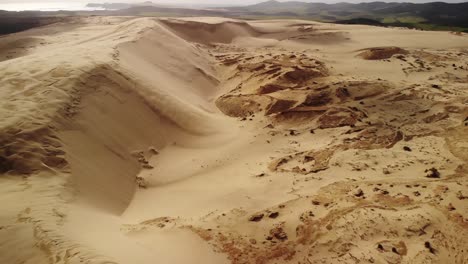 small golden sandy desert, aerial look down to steep sand dune slope