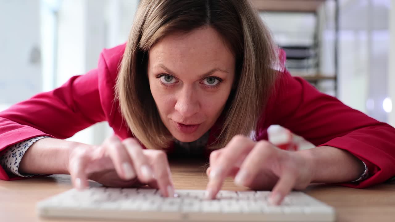 Woman intensely typing on a keyboard