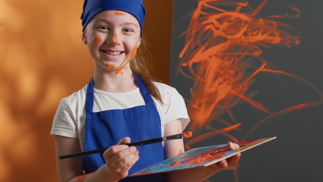 Girl artist painting in the studio