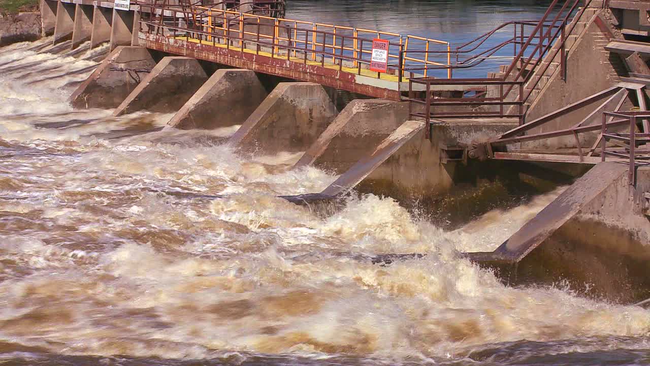 A dam handles fast flowing water in a river 1