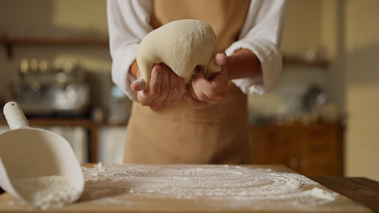 Woman kneading dough in a kitchen
