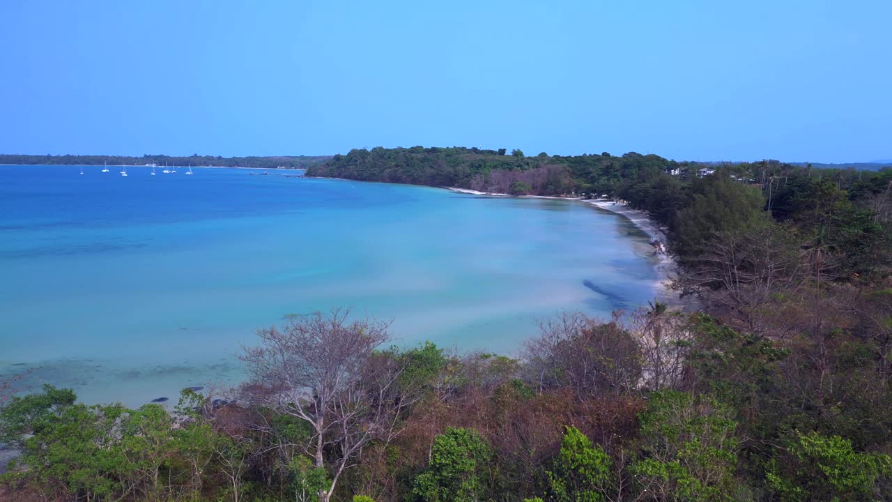 Koh Mak tropical beach meeting turquoise water under blue sky in Thailand. Marvelous aerial view flight drone speed ramp hyper motion time lapse