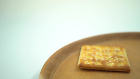 christmas cracker biscuit over the wooden plate, fork and spoon with white background.