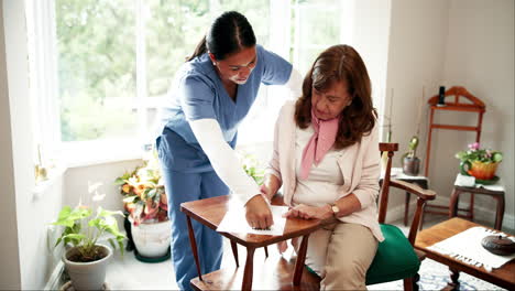 caregiver assisting senior woman with sudoku puzzle