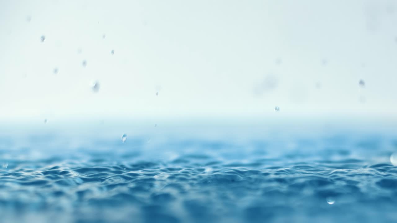 Rain water drops falling in super slow motion.