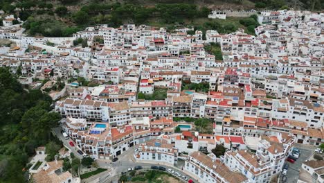 rising drone shot overlooking traditional buildings in mijas, spain