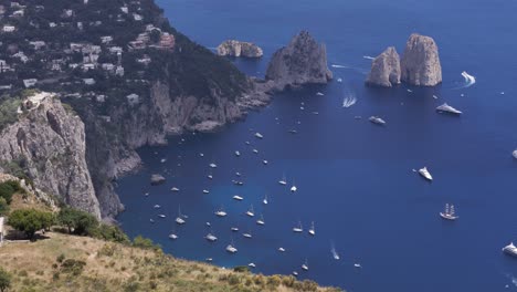 aerial static drone shot offering a close-up view of the famous faraglioni rocks, highlighting their natural beauty