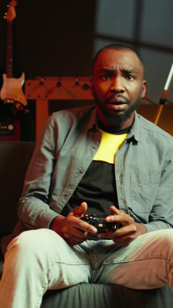 Vertical video Man putting face in hands in frustration after being defeated in videogame