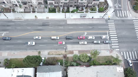 Traffic-stops-at-a-red-light-intersection-off-a-boulevard-in-Los-Angeles-near-condos