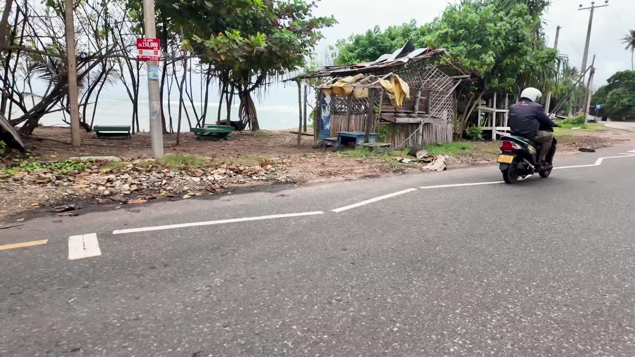 POV drive along the coastal road in Marissa, Sri Lanka, with the beach and lush greenery providing a serene, tropical backdrop.