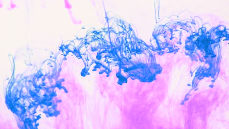 4k footage of colorful ink drops in water, isolated abstract background. pouring ink in water. underwater paint mix. slow psychedelic dye swirls, colored smoke explosion. splashing, floating liquid