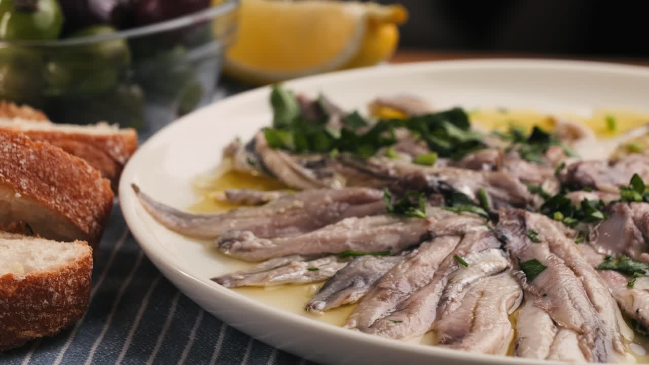 Fresh Sea sardines and Anchovy Fish and Mullus On Display On Ice On Market Store Shop. Seafood Fish Background, close up stand of small salty white fish.