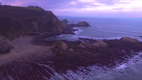 Revealing-aerial-view-of-asturias-beach-on-a-cloudy-winter-morning-drone-point-of-view
