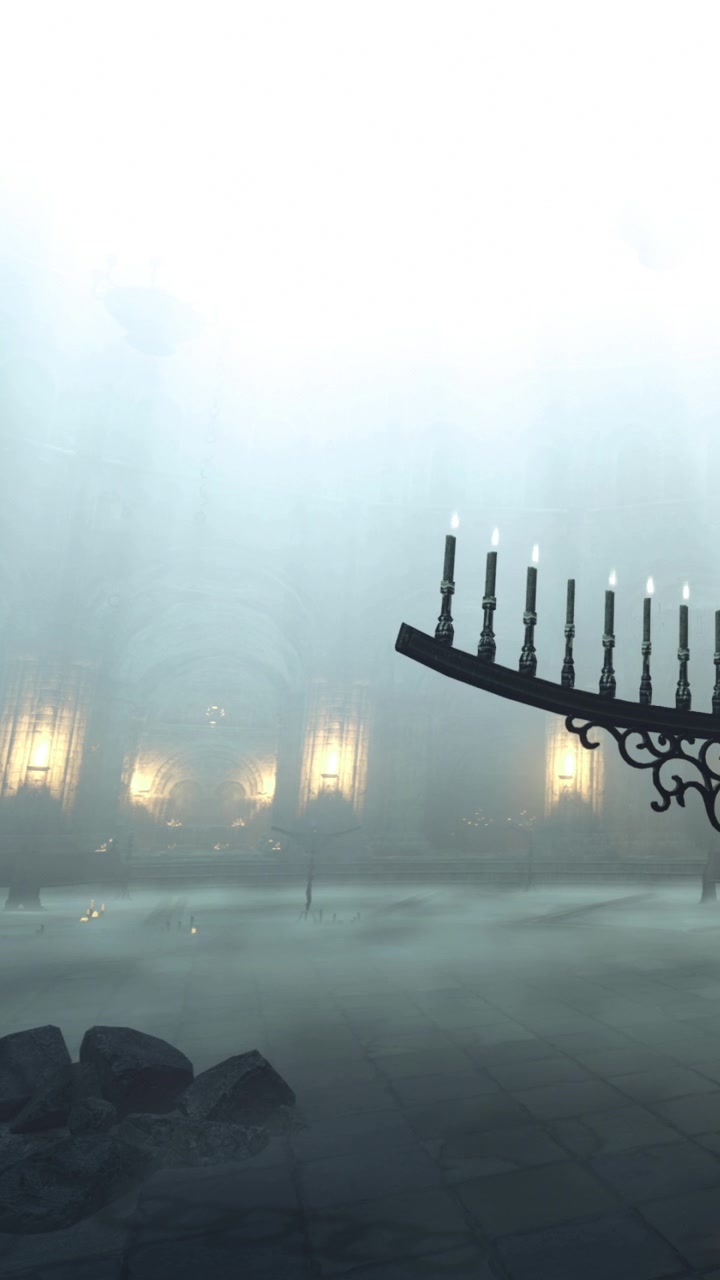 Fog fills the room where a candelabra stands next to rocks and stone floor