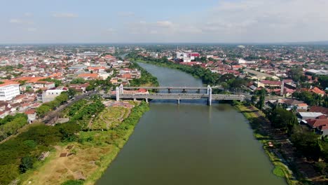 Aerial-view-of-road-traffic-crossing-Brawijaya-bridge-in-Kediri-,-Java-Indonesia