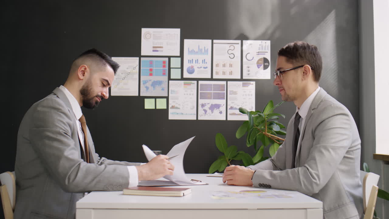 Business Partners Signing Contract and Shaking Hands