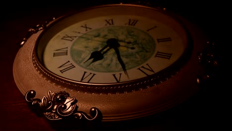 concepto de tiempo. gran reloj redondo vintage en mesa de madera con luz abstracta. atmósfera oscura. decoración creativa. enfoque selectivo