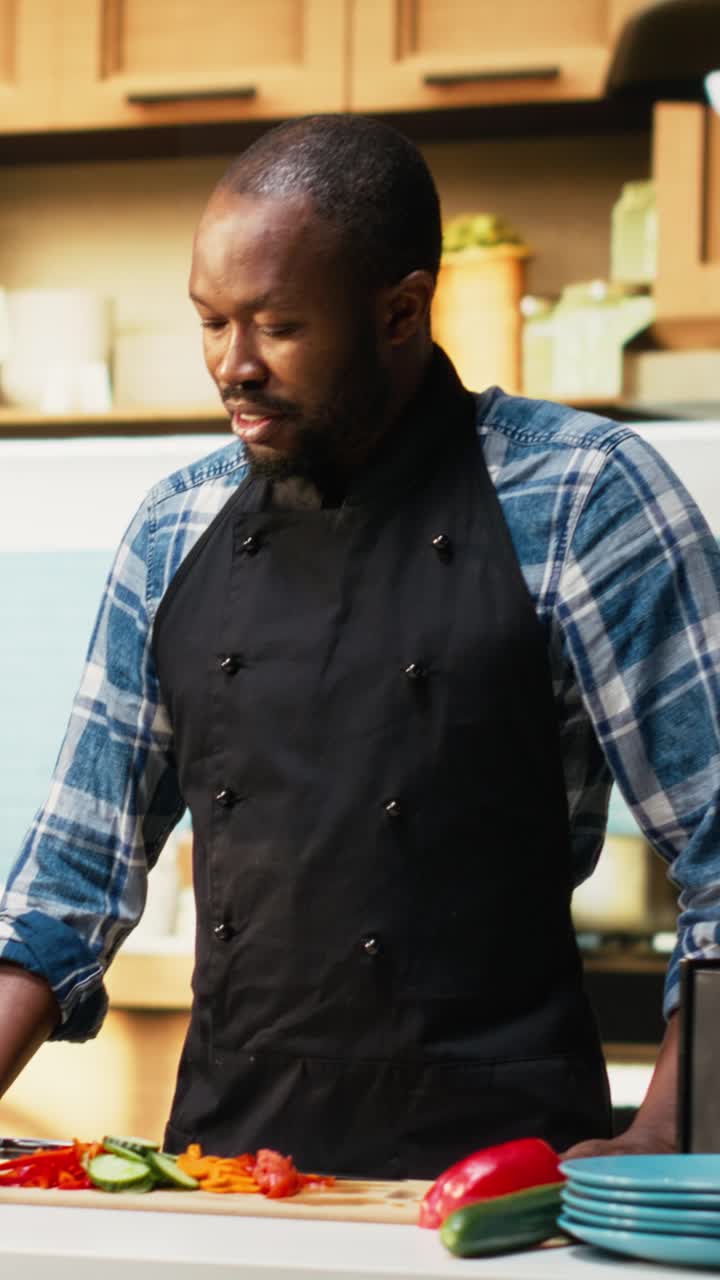 Vertical Video Black man and woman adding freshly cut vegetables from the cutting board
