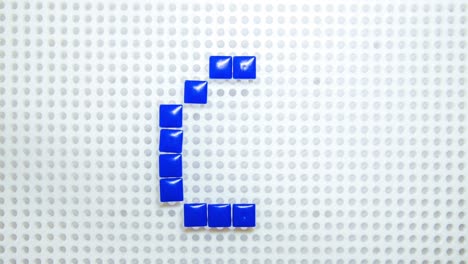 stop motion of the number 6 creating one pixel at the time, made with children toys