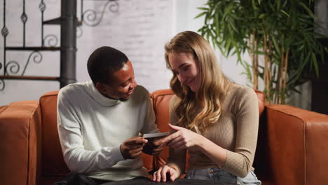 black man looks at ultrasonic pictures of pregnant wife