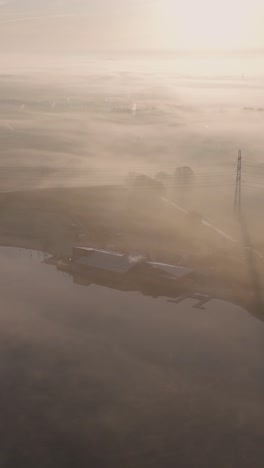 Misty Morning Over a Lakeside Building