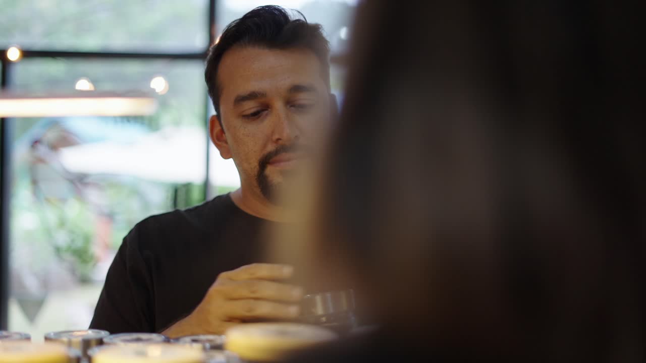 Man Performing Sensory Evaluation and Interacting in a Shop