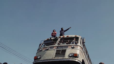 people on top of a bus