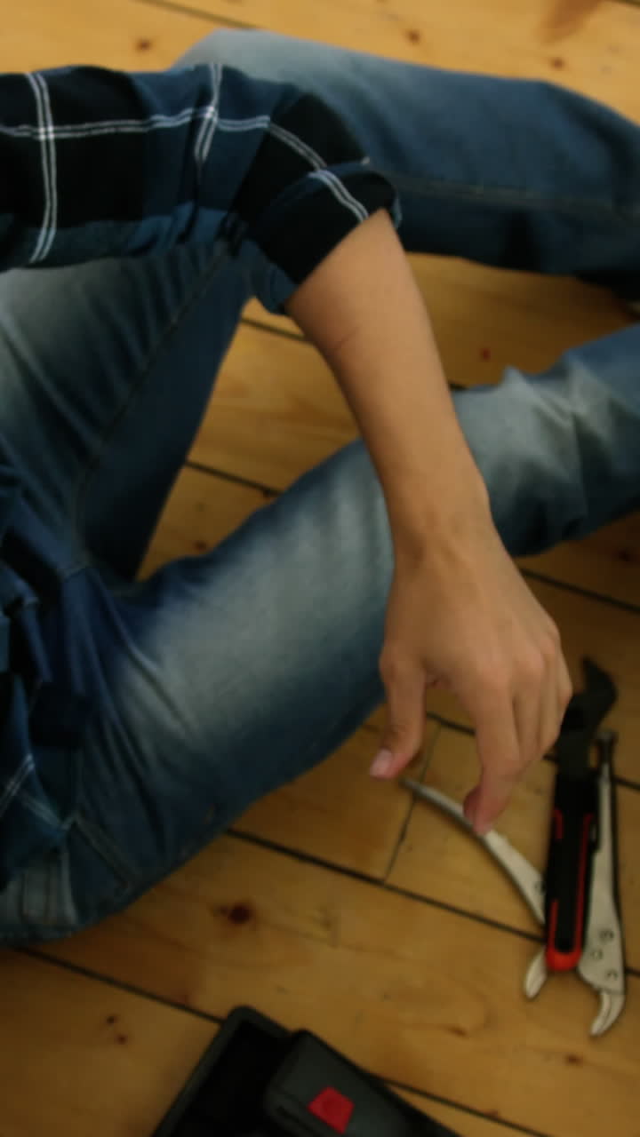 Plumber is looking for his wrench in his tools box